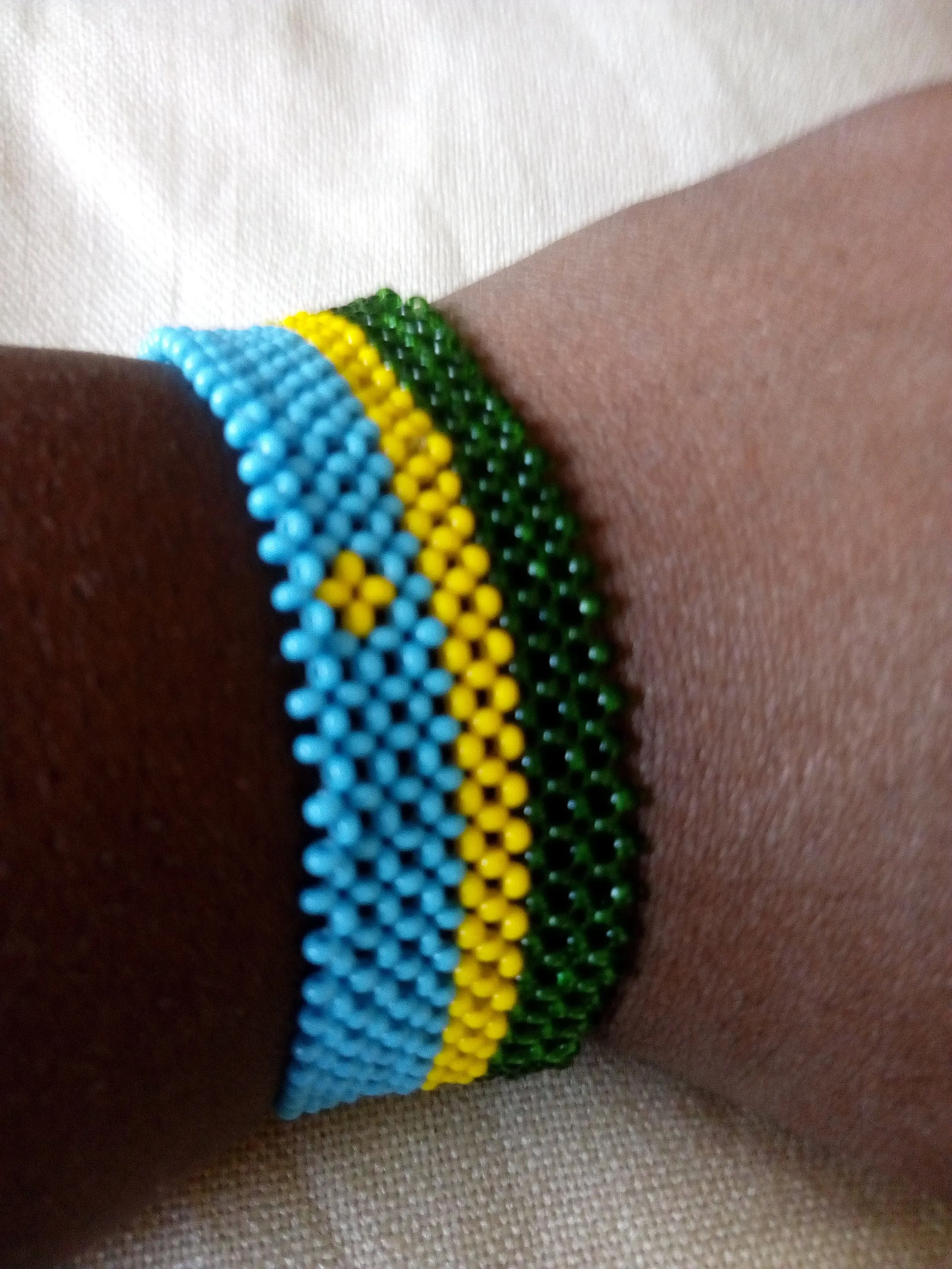 Rwanda flag beaded bracelet handmade from Kenya by the masaai/maasai community